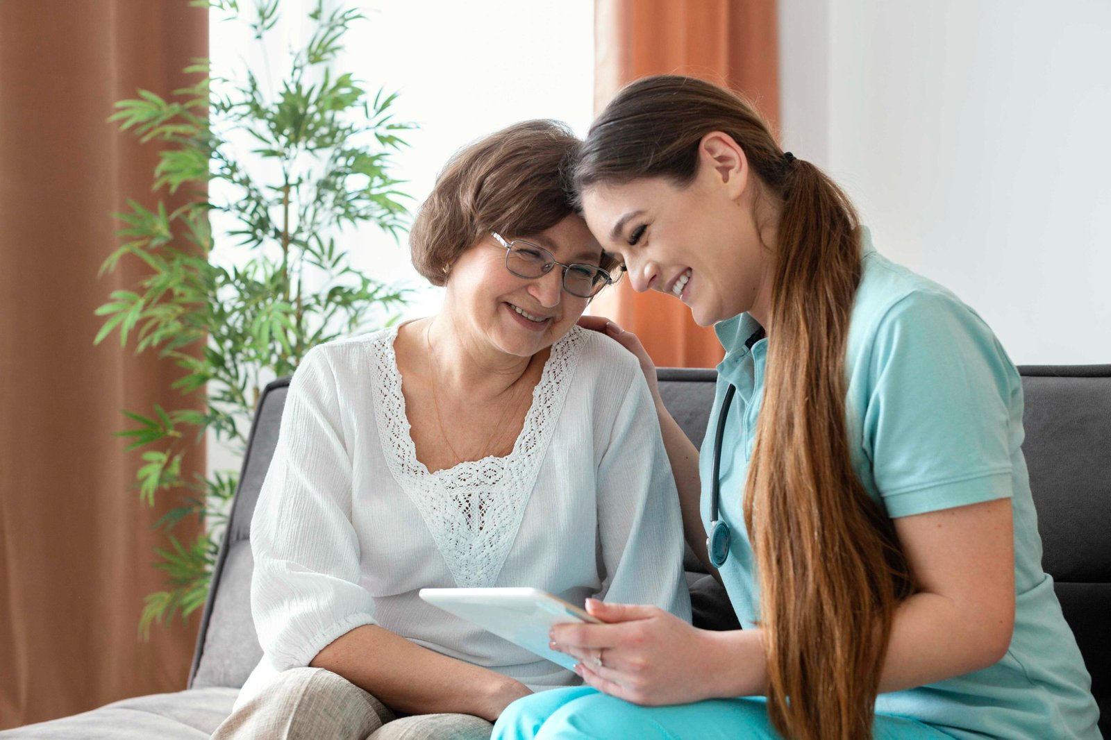 A nurse reviewing a personalised digital care plan with a client