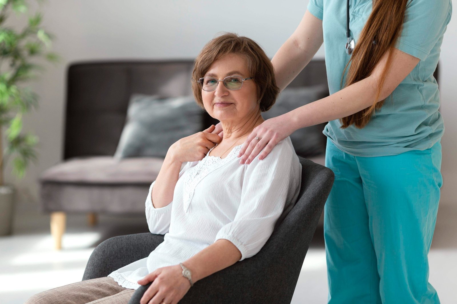 A nurse providing calm reassurance to an older person at home