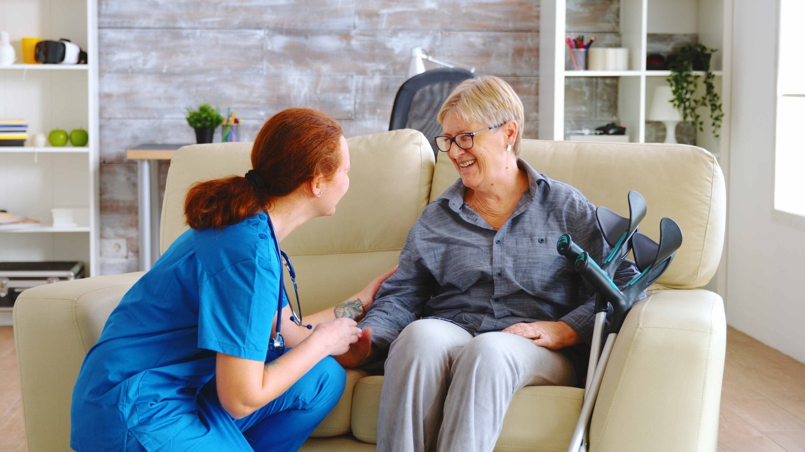 A nurse supporting a client who uses crutches at home